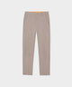 Macade Links Tech Trouser in tan displayed flat, featuring a tailored silhouette, front pockets, and a hint of the orange silicone-lined waistband for a secure, comfortable fit.