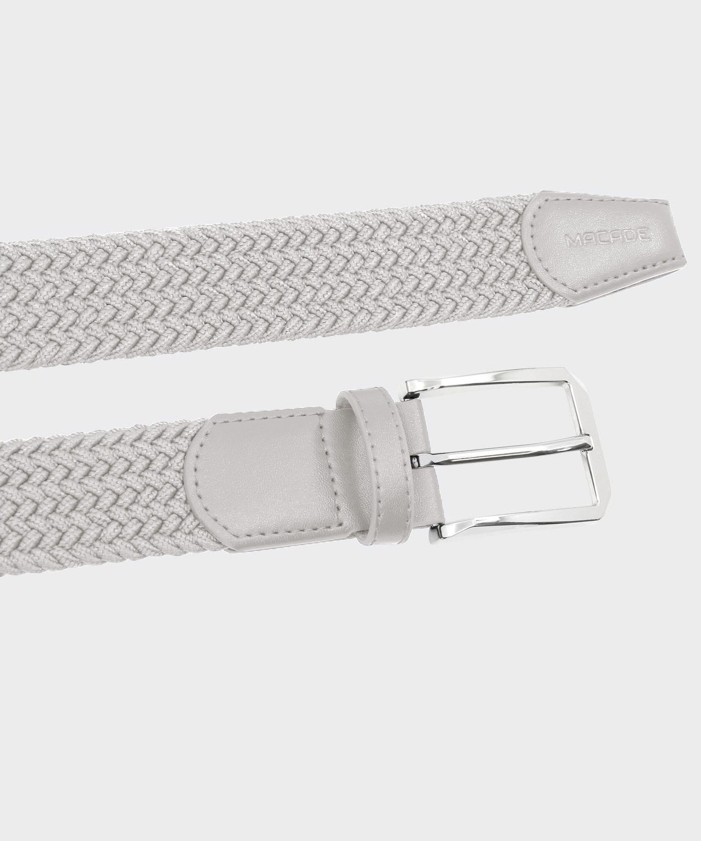 Macade Golf Elastic Belt in bone white with a braided elastic polyester strap, polished stainless steel buckle, and minimal leather trim featuring subtle embossed branding for a clean, modern finish.