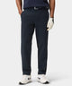 Men’s navy Links Tech Trouser styled with a navy polo, golf glove, and sneakers, highlighting the tailored fit and clean lines ideal for both golf and everyday wear.