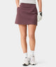 TX Air Skirt in mauve worn by a woman golfer, featuring a wide waistband, discreet front pockets, and a modern, streamlined fit designed for comfort and versatility on and off the course.