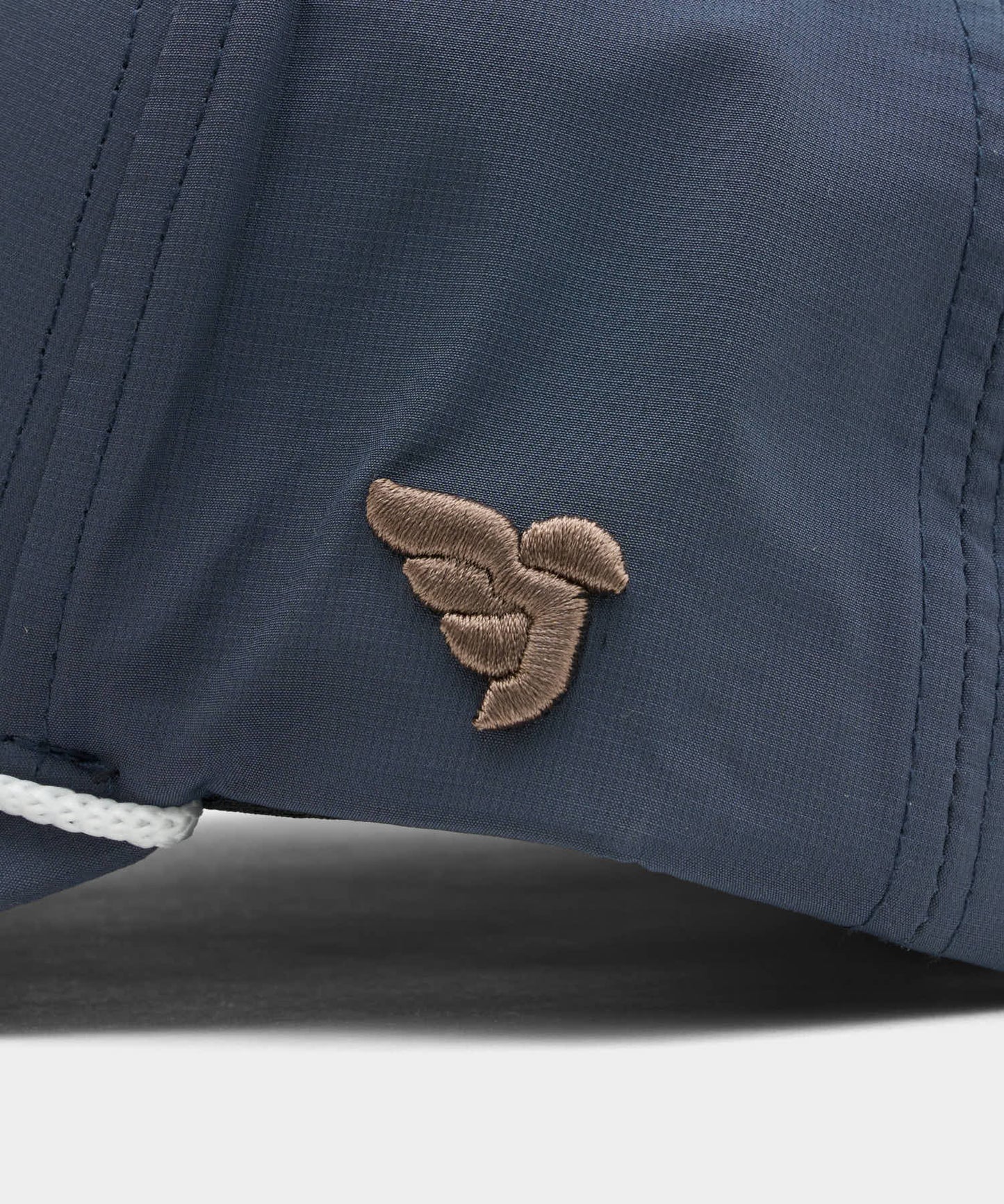 Detail of the Rope Course Snapback in Stone blue, highlighting the tonal stitching, subtle Macade logo embroidery on the side, and the premium rope trim above the brim.