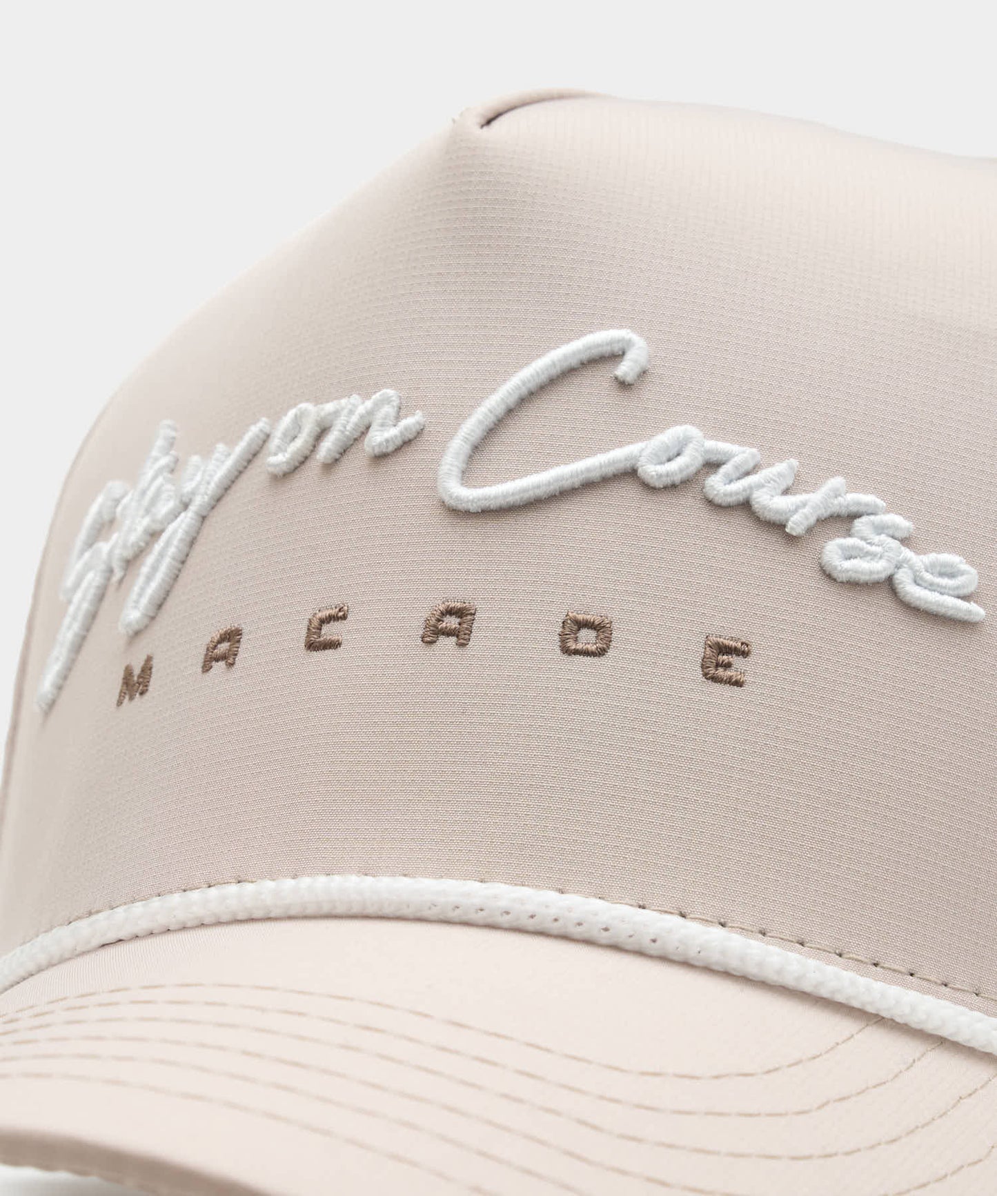 Close-up of the Rope Course Snapback in Tan, highlighting the white script embroidery, subtle MACADE branding, and the premium rope detail above the structured brim.