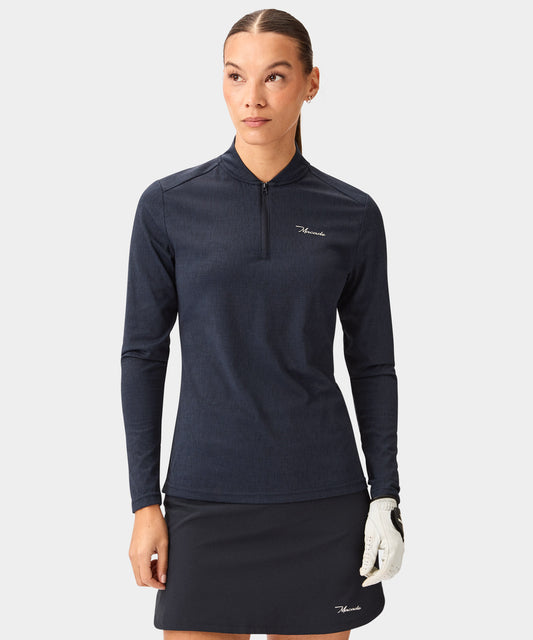 Woman wearing a navy Dawn Long-Sleeve Bomber Shirt with a sleek bomber collar, minimalist quarter-zip, and subtle textured fabric, styled for golf with a matching skirt and white glove.