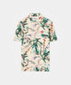Man wearing the TX Relaxed Shirt in the Badlands print, featuring a vibrant botanical pattern, relaxed fit, and minimal branding, styled with neutral golf pants and a cap for a modern, standout look on or off the course.