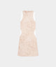 Woman wearing the Macade Golf Inez Sleeveless Dress in a beige botanical print with white side panels, featuring a fitted, above-the-knee silhouette and minimal branding, designed for modern golf style and versatile everyday wear.