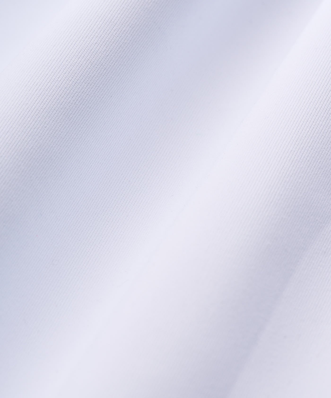 Detailed close-up of the Therma Quarter Zip fabric in white, showcasing its smooth, tightly woven texture and premium polyester-spandex blend for a soft, flexible finish.