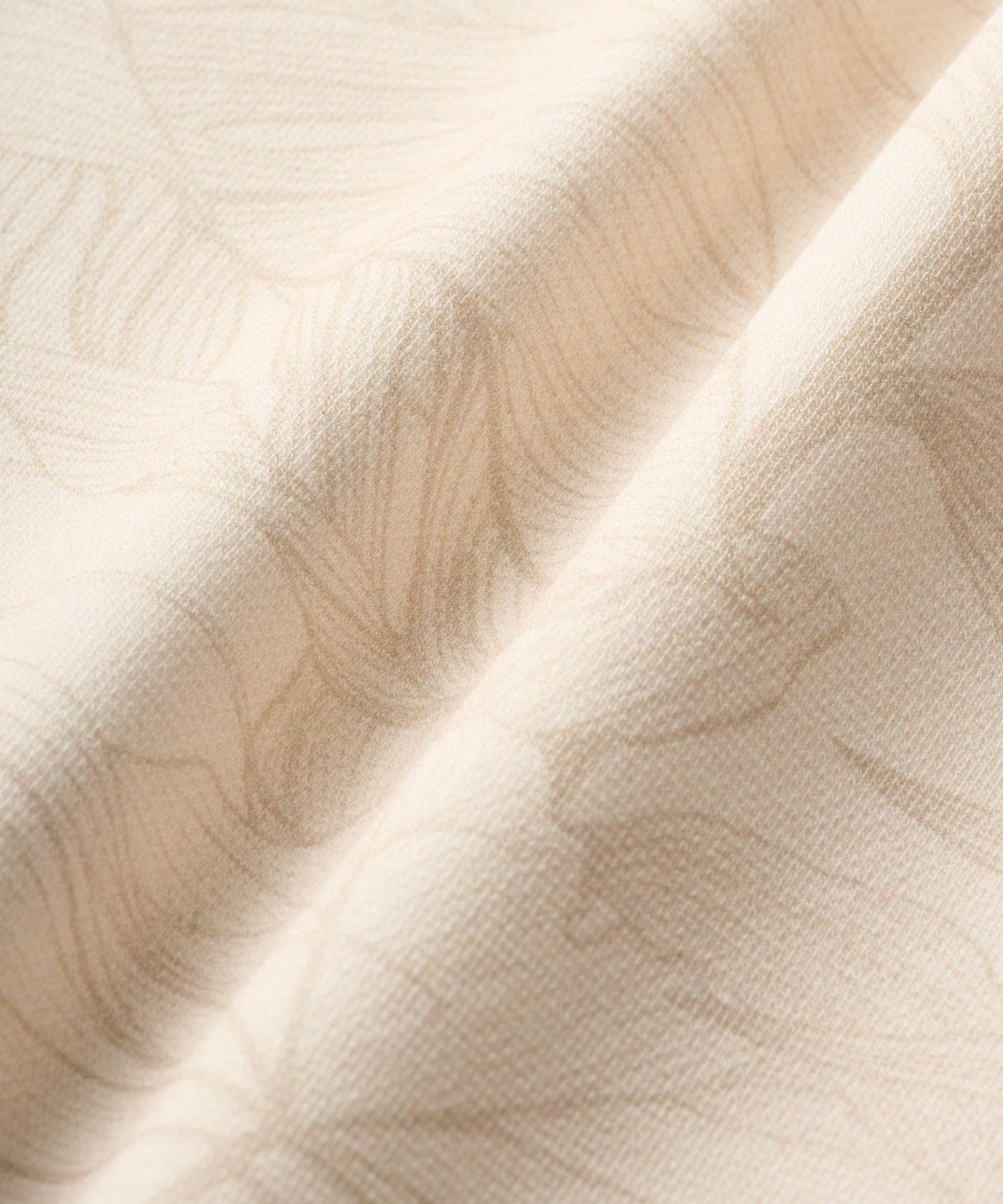 Close-up of the Blades Polo Sweatshirt in Palm Beige, highlighting the premium textured jersey fabric with a subtle tonal leaf pattern for an elegant, modern finish.